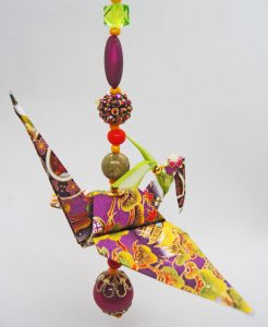 Paper Crane folded with purple, gold, and green Washi paper